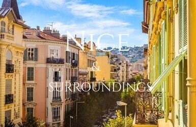 A street in Nice lined with houses painted in bright yellow and orange with green shutters and ornate metalwork on their small balconies.